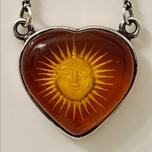 Vintage Amber and sterling silver necklace. Sun face carved into Amber heart.